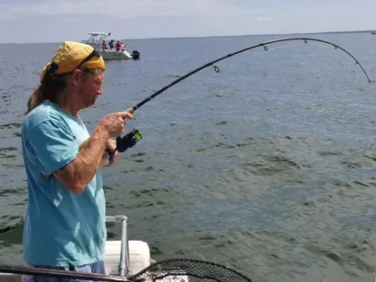 A customer battles a trophy rockfish to the boat